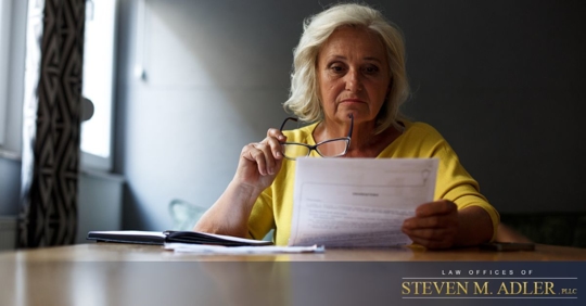 Older woman looking over paperwork
